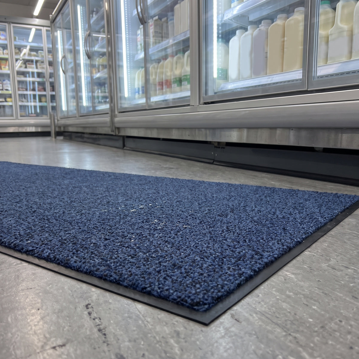 Deep Blue made to measure runner mat laid in front of supermarket chiller cabinets to catch drips and spills
