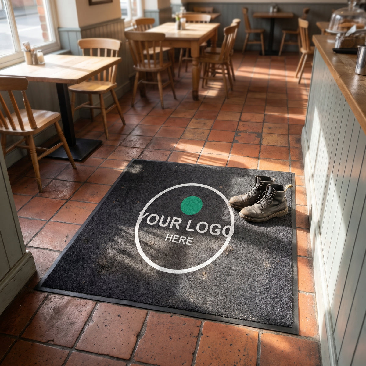Square custom logo mat inside a café entrance on tiled floor
