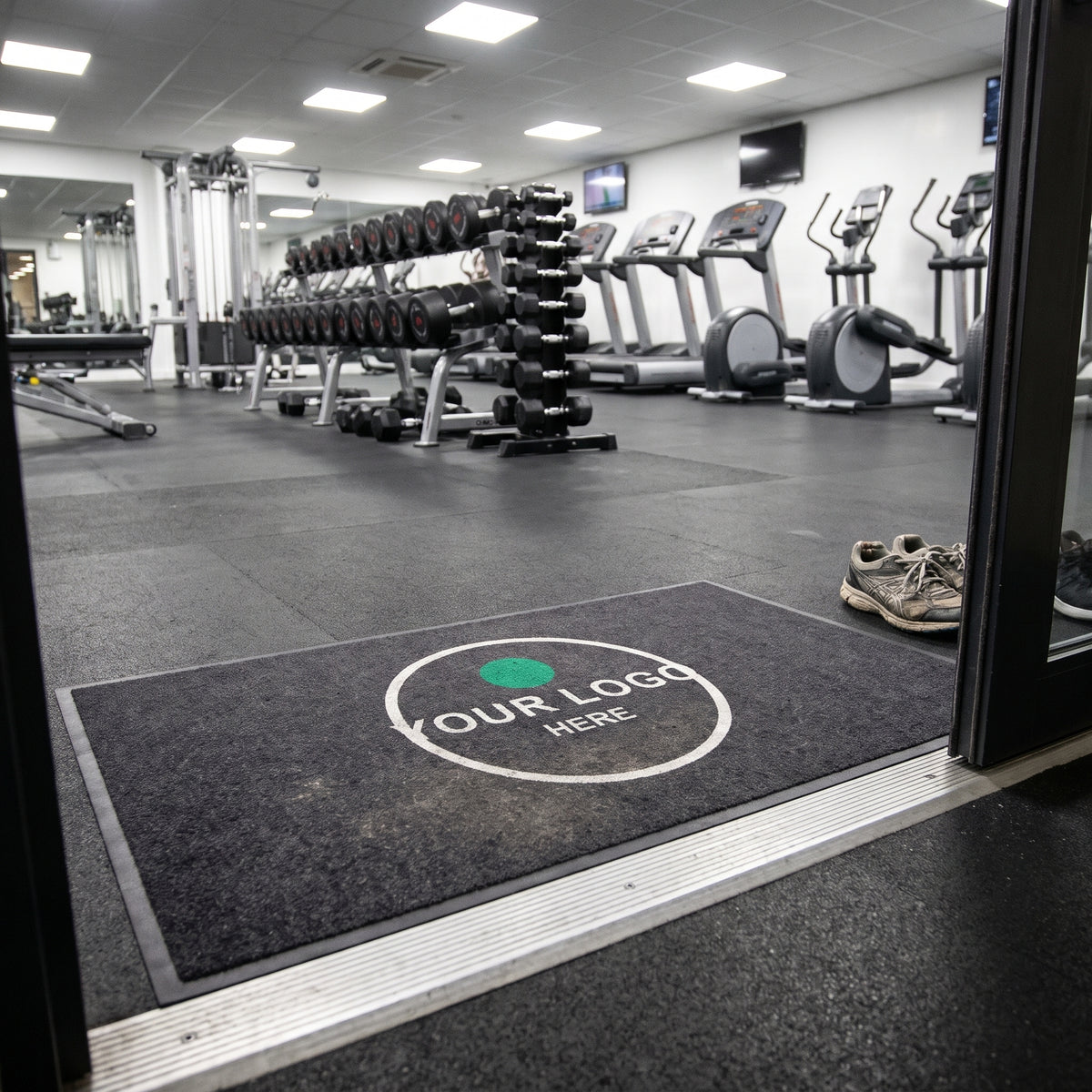 Printed logo mat at the entrance to a commercial gym