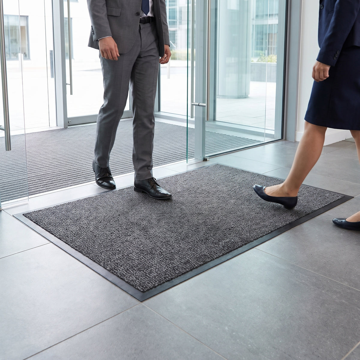 Low-profile entrance mat in use at a corporate office lobby entrance