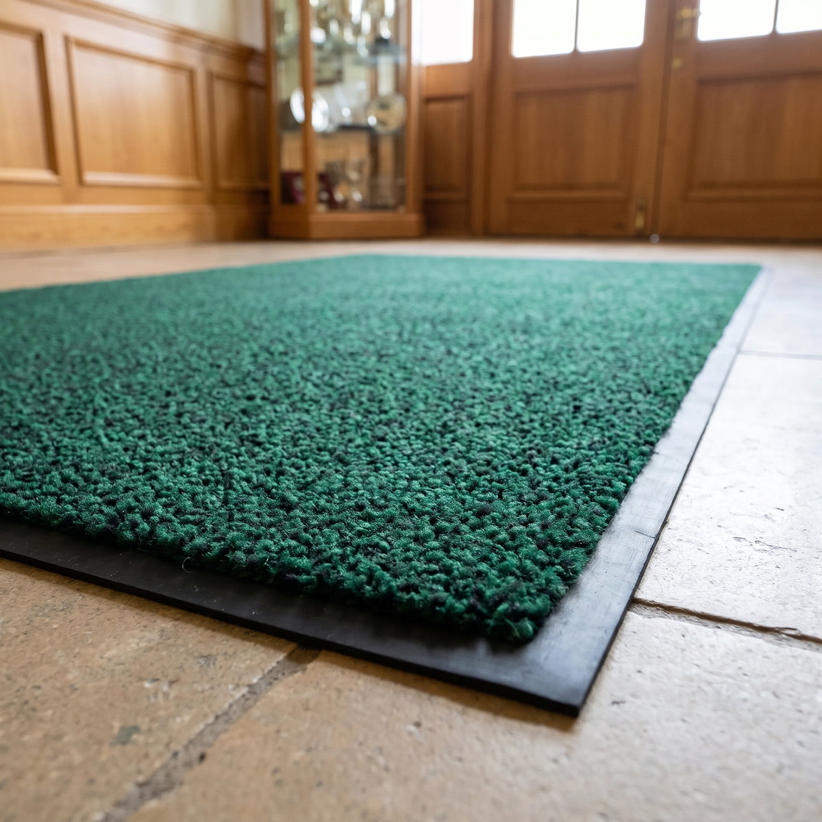 Green and Black commercial made to measure entrance mat on stone flagstones