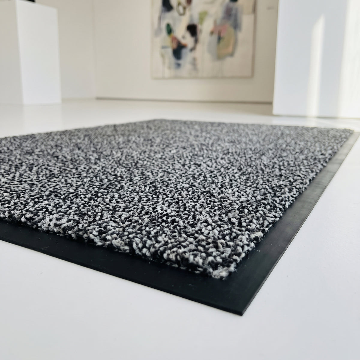 Light Grey commercial made to measure entrance mat, close-up of 10mm plush pile and rubber border