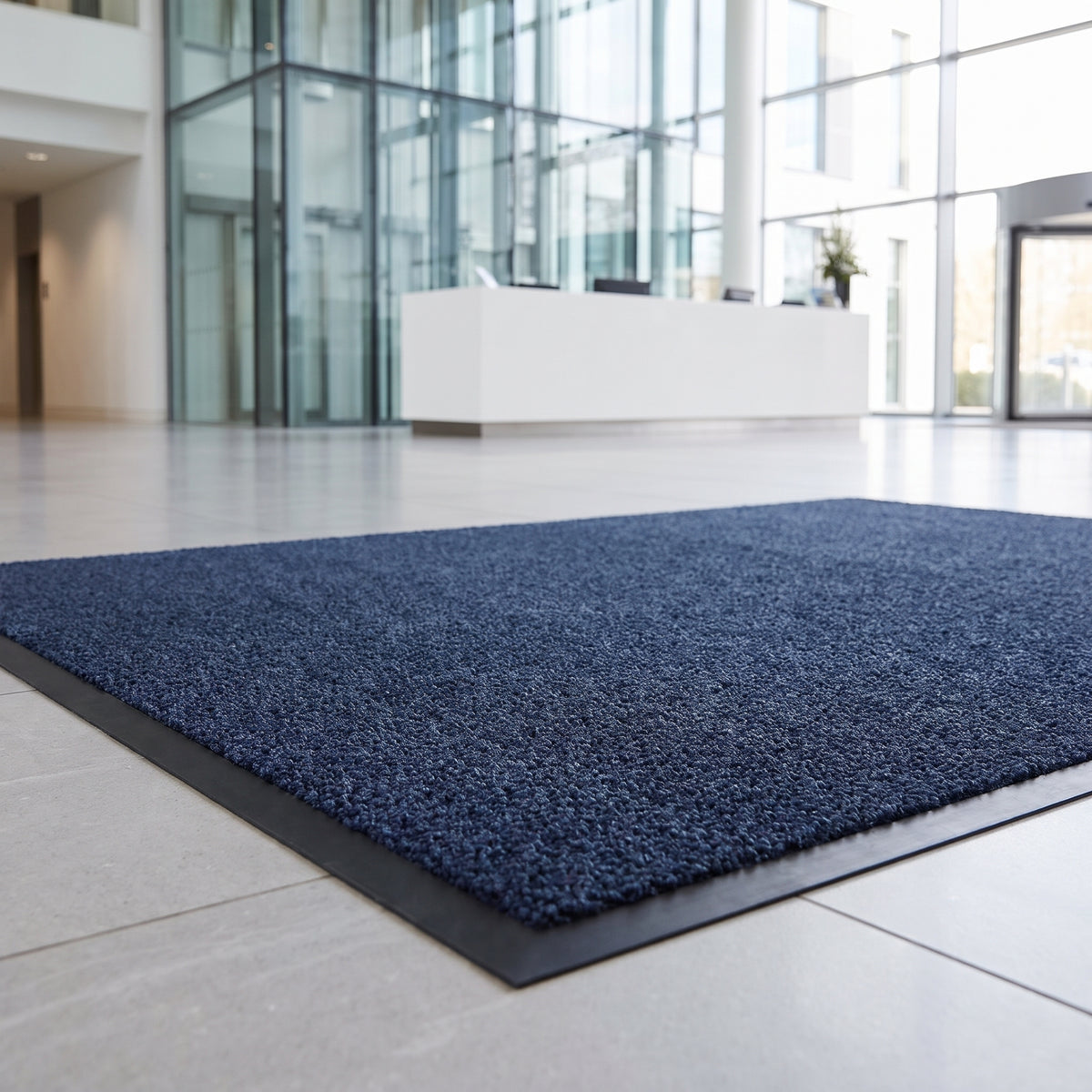 Deep blue machine washable entrance mat at a corporate reception entrance in daylight