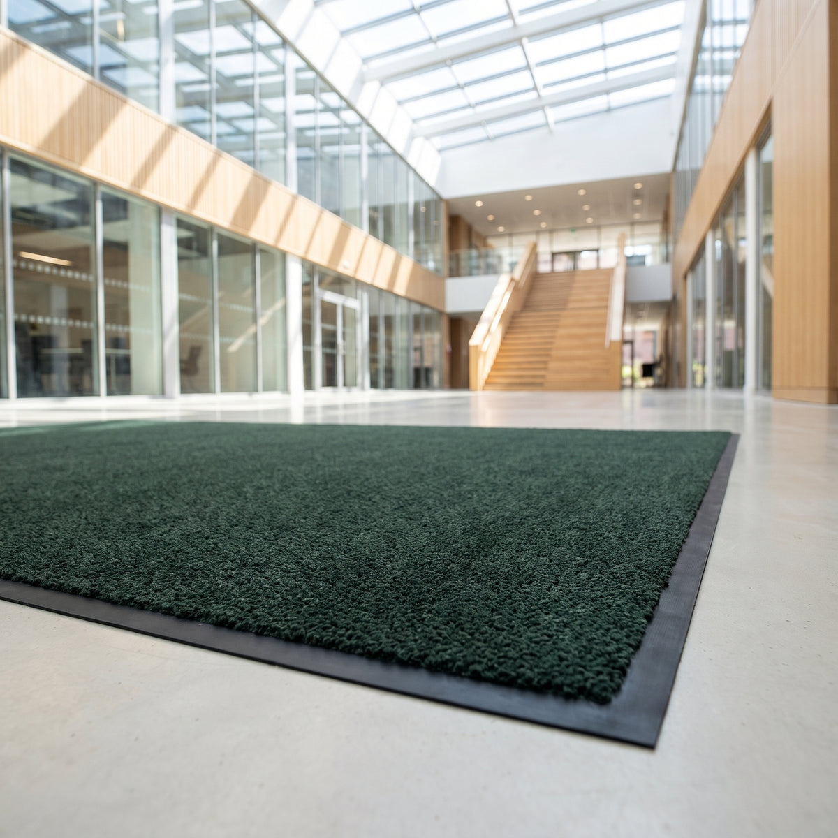 Forest green machine washable entrance mat in a university atrium