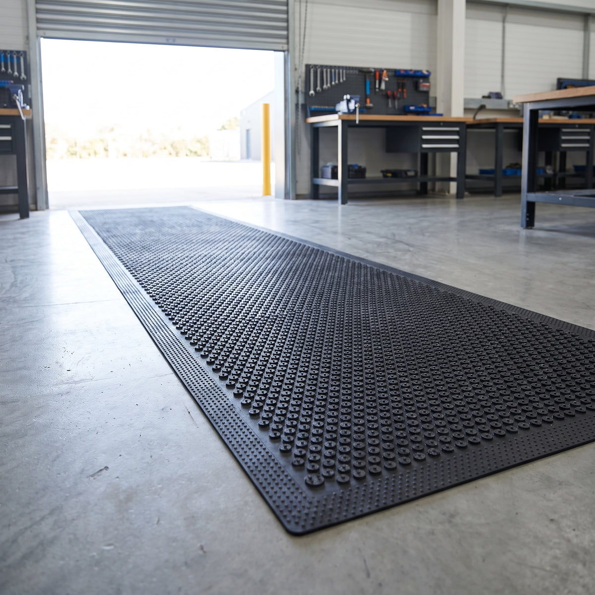 Nitrile rubber scraper runner mat inside a workshop roller-shutter entrance