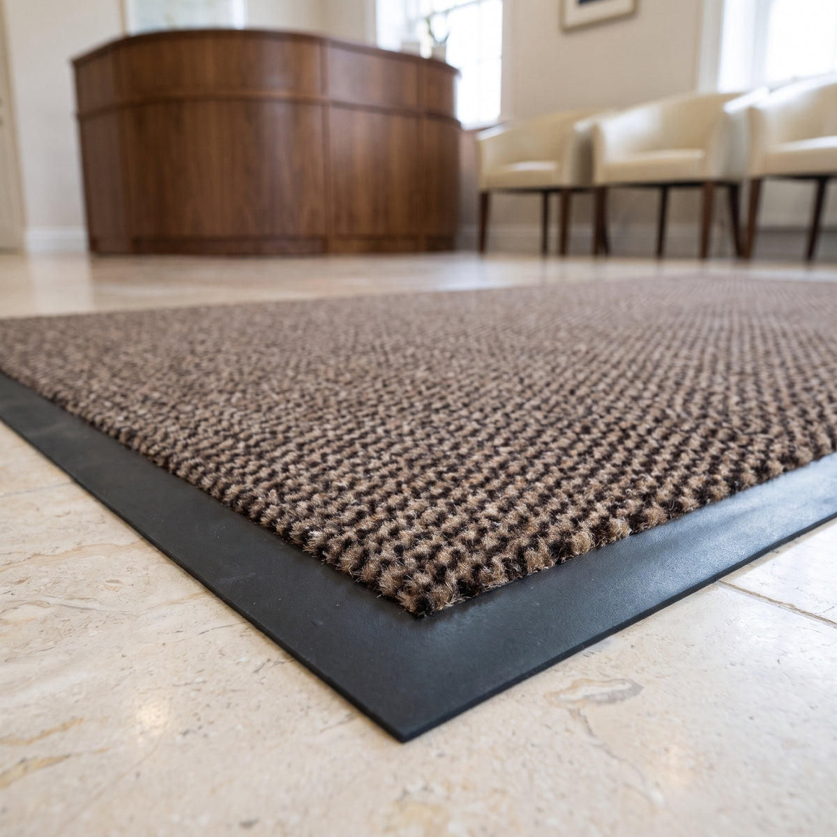 Close-up of brown Slimline entrance mat pile and border in a private clinic reception on limestone